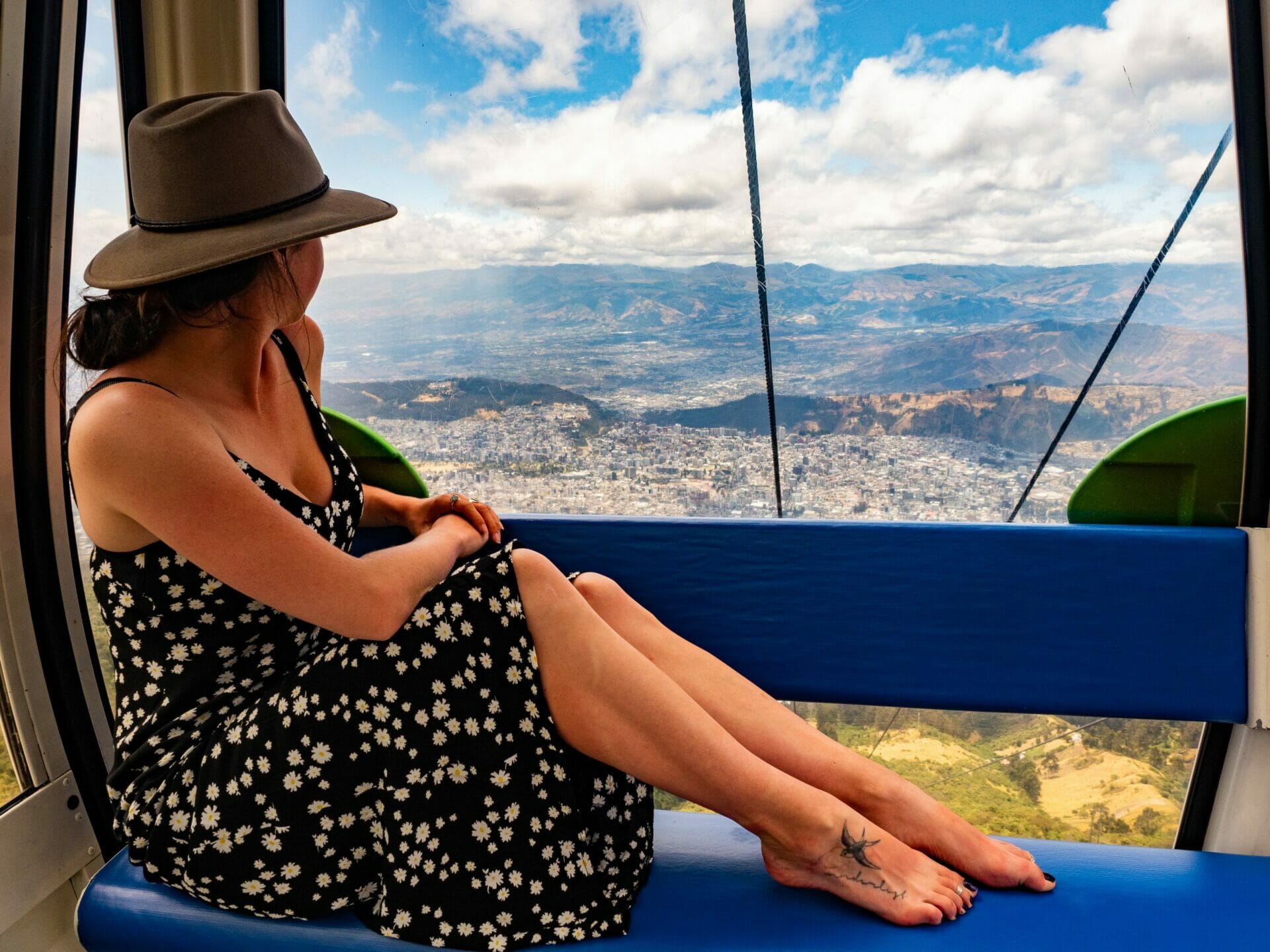 Girl riding TelefériQo cable car over Quito