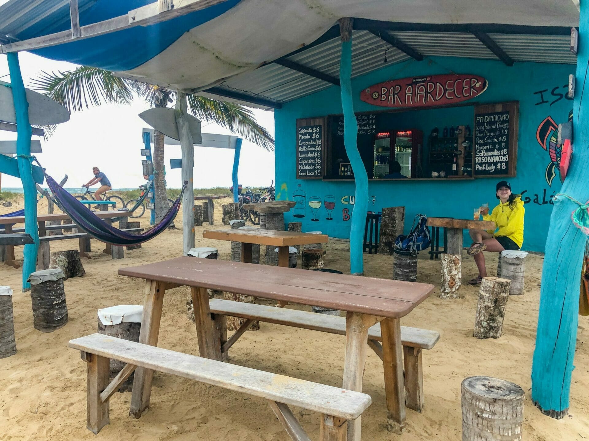 Girl sitting at outdoor beach bar Isla Isabela