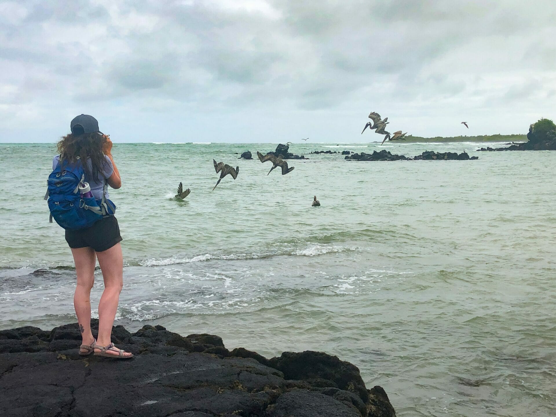 Girl taking photo of birds at Mirador Los Tunes