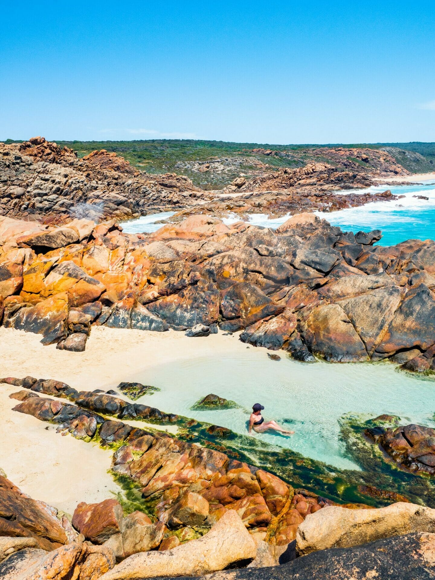Girl laying in rock pool Injidup Natural Spa Western Australia