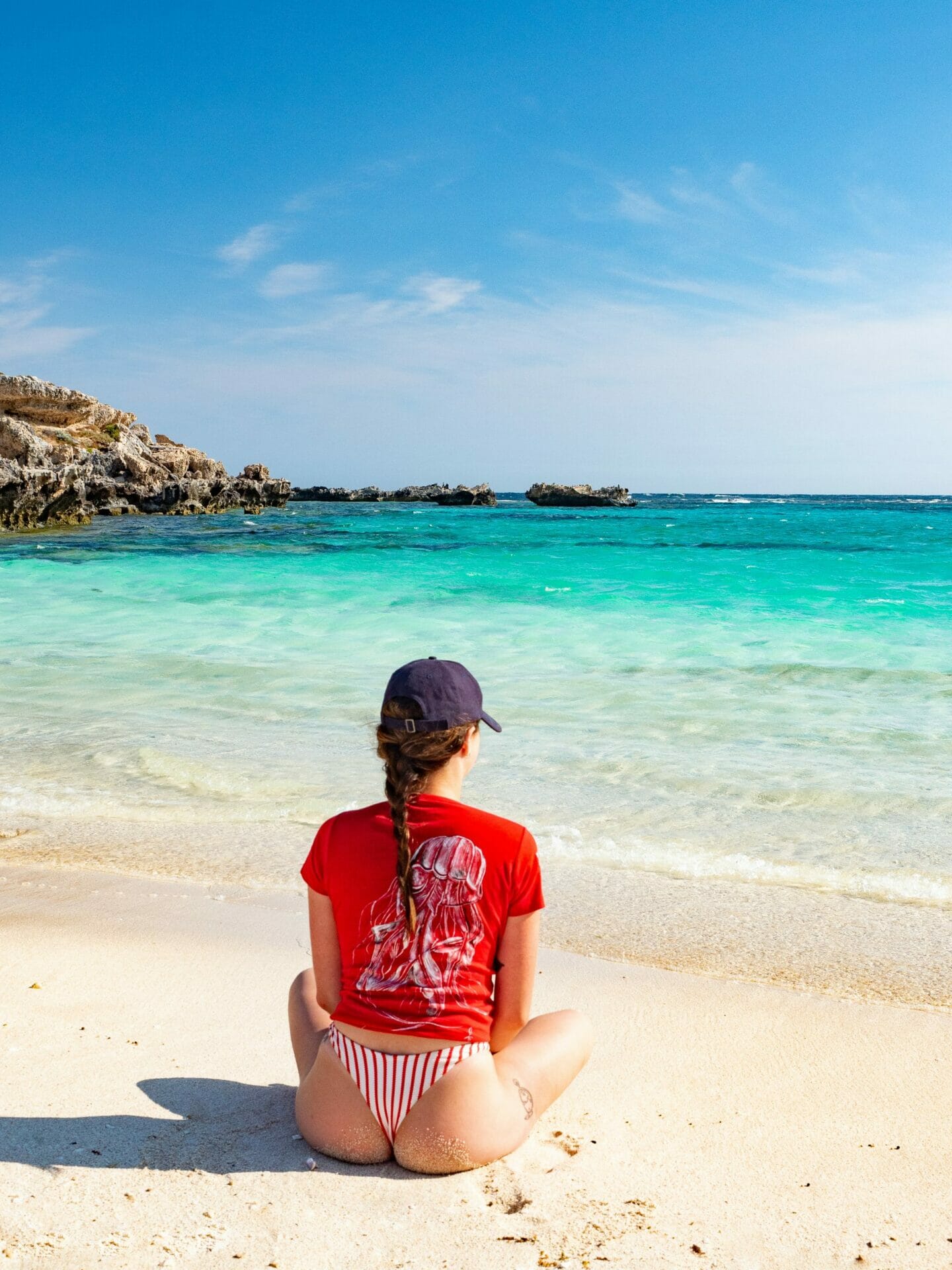 Girl sitting on beach Rottnest Island Western Australia