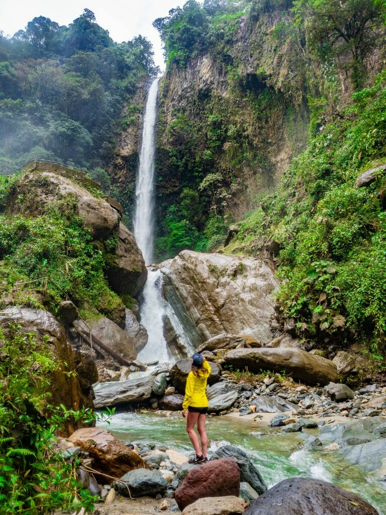 Girl standing in front of Cascada Rocio Machay waterfall 